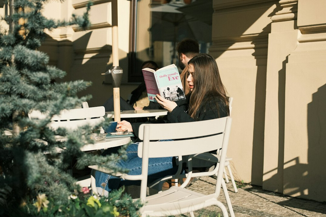 person reading book outdoors