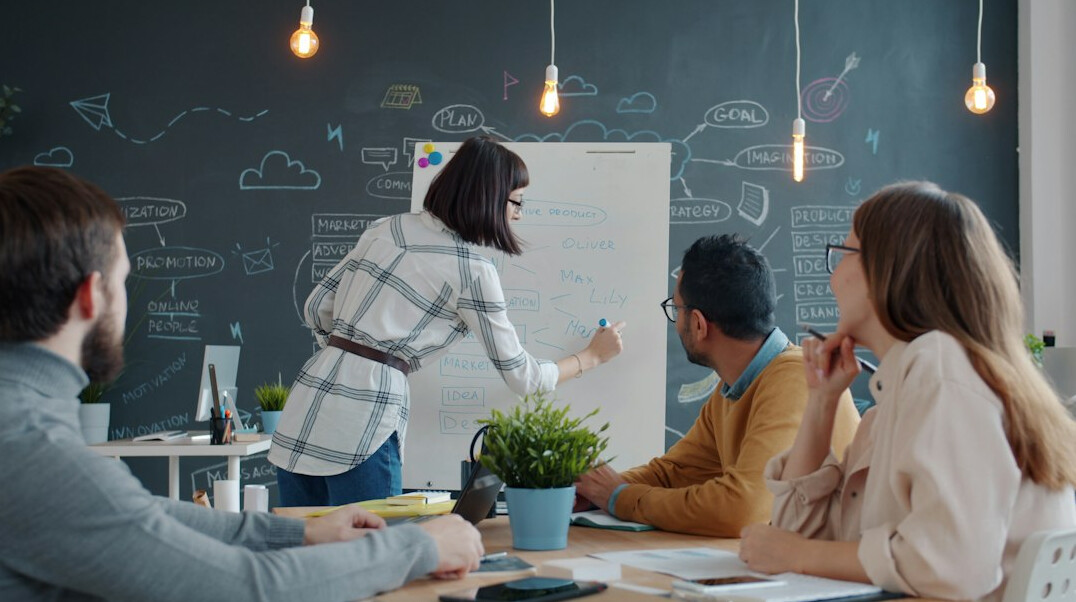 woman explaining idea to group